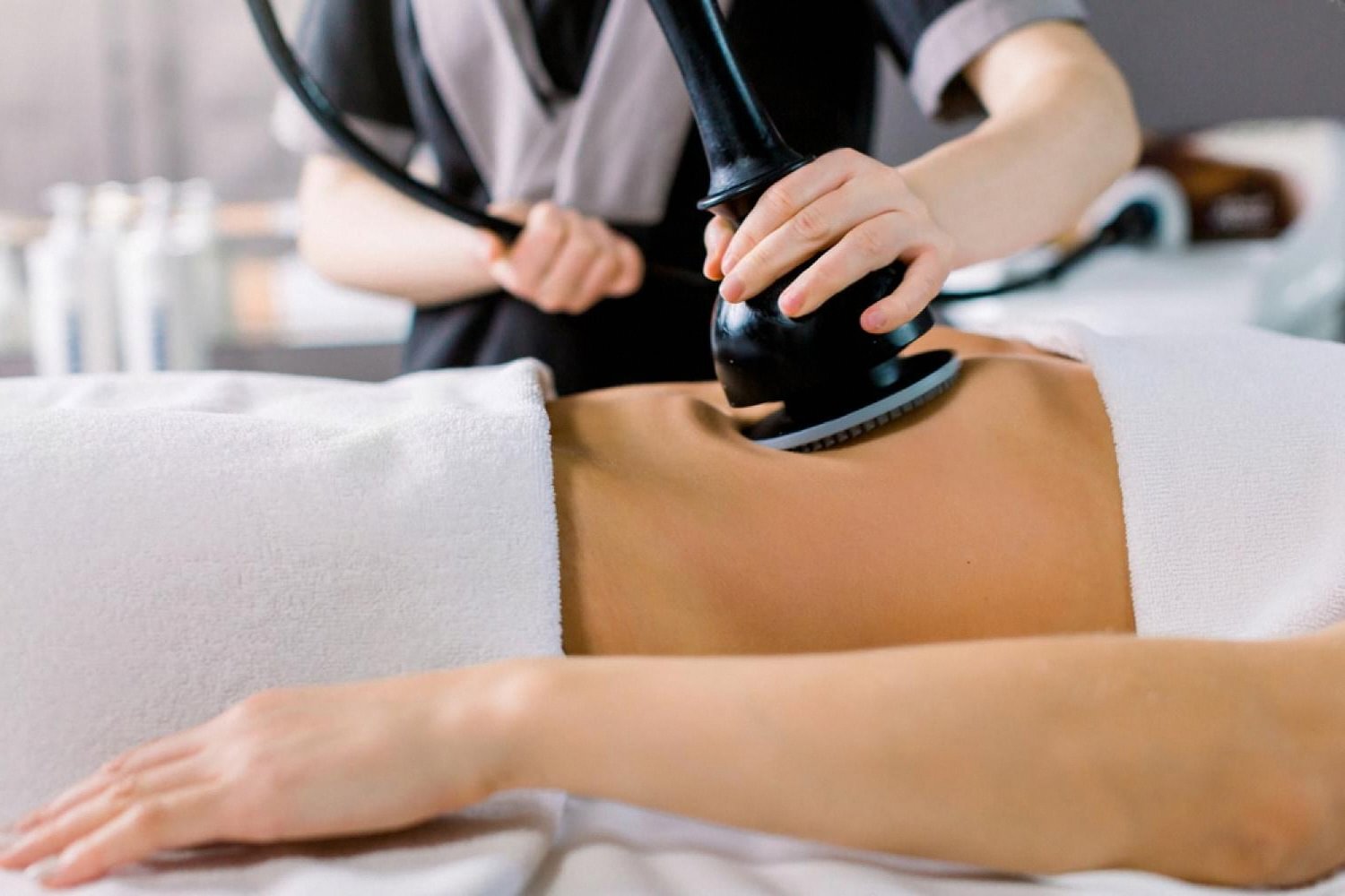 Body contouring device used during a slimming treatment on a client's abdomen